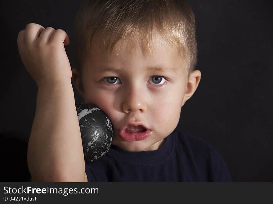 Portrait of the serious boy on a black background. Portrait of the serious boy on a black background