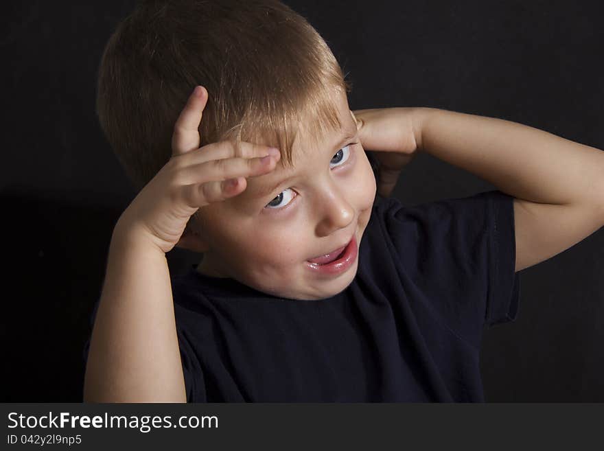 Portrait of the boy on a black background. Portrait of the boy on a black background