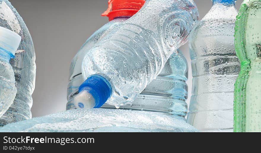 Bottled water over a grey background