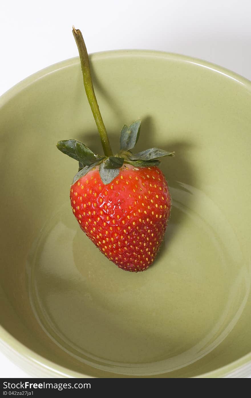 Strawberry shot inside the bowl. Over white background. Strawberry shot inside the bowl. Over white background