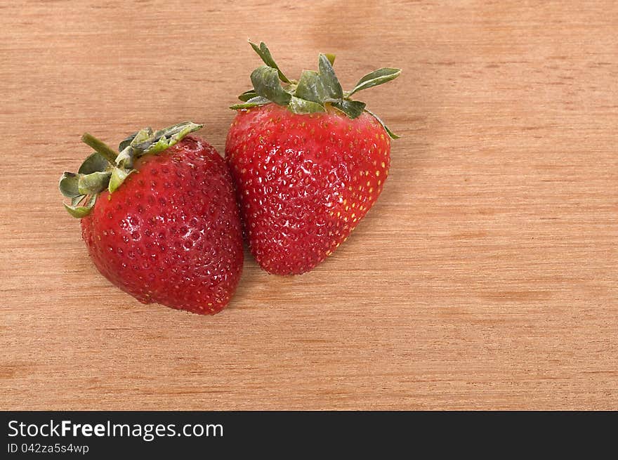 Strawberry on the wooden table. Shot in the studio