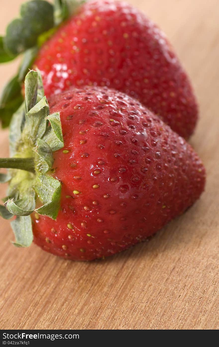 Strawberry on the wooden table. Shot in the studio