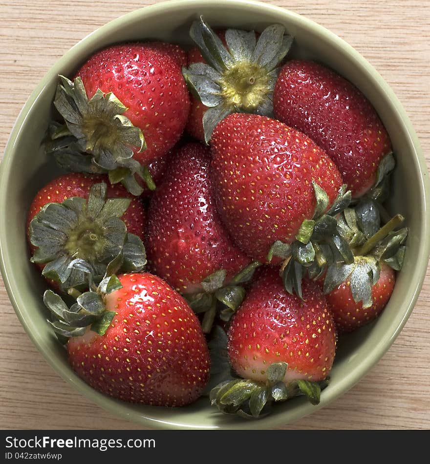 Strawberry on the bowl, good for your design. Shot on wooden background