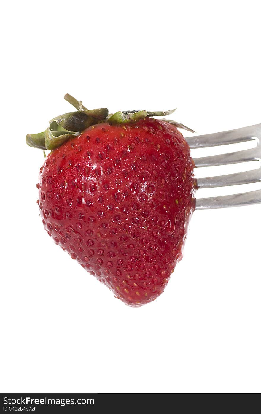 Strawberry on the fork isolated over white background. Strawberry on the fork isolated over white background