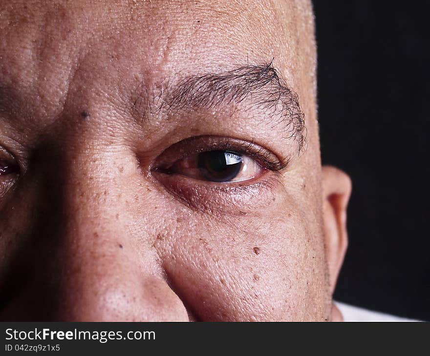 An old man's eye looking at camera. An old man's eye looking at camera