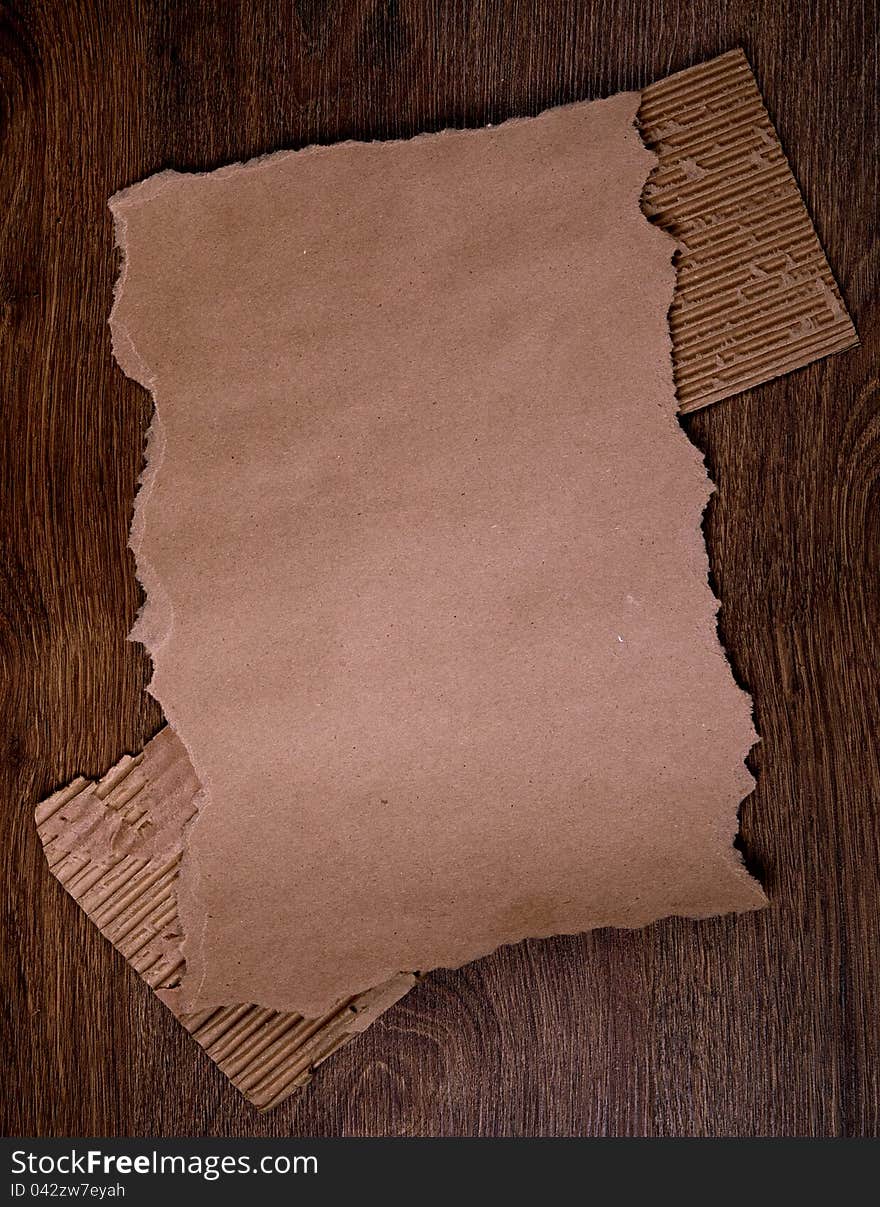 Old brown paper on the wood  background. Old brown paper on the wood  background