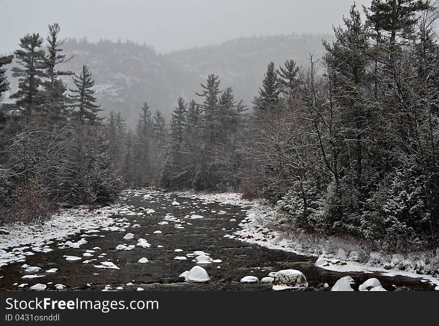 Winter first snow scenery with mountain river in White Mountains, NH