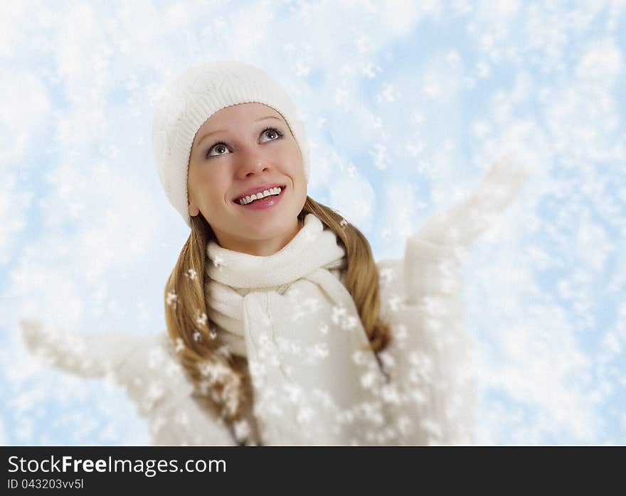 Christmas portrait of a beautiful happy girl with snowflakes on a winter background. Christmas portrait of a beautiful happy girl with snowflakes on a winter background