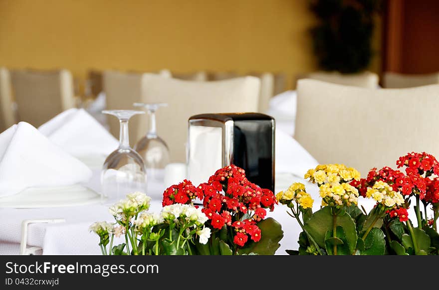 Table set served with silverware, napkin and glassware at restaurant. Table set served with silverware, napkin and glassware at restaurant