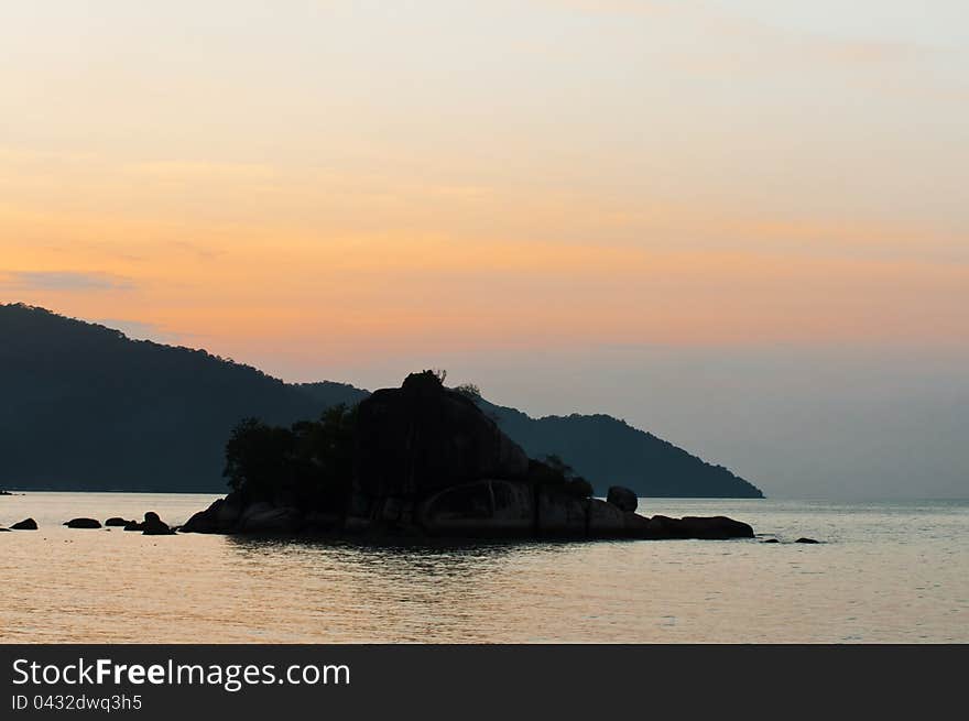 Silhouette view of small island and mountain during sunset at Feringghi beach, Penang. Silhouette view of small island and mountain during sunset at Feringghi beach, Penang