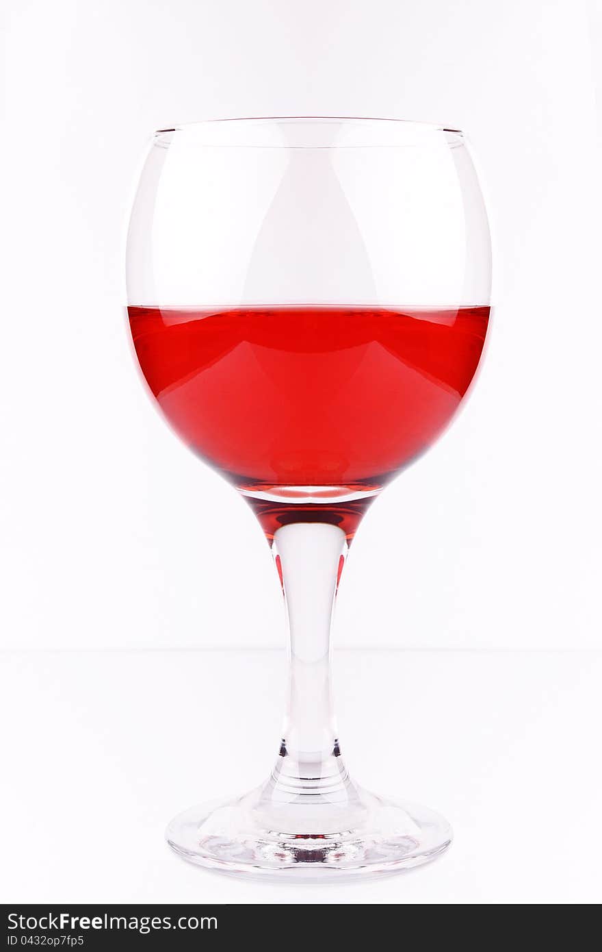 A glass of red wine on white, studio shot