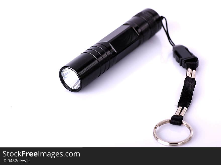 Metal coated flashlight  on white. Metal coated flashlight  on white.