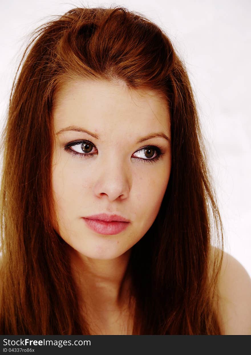 Pretty brunette woman with perfect pout, pink lipstick looking up slightly. Light background. Pretty brunette woman with perfect pout, pink lipstick looking up slightly. Light background.