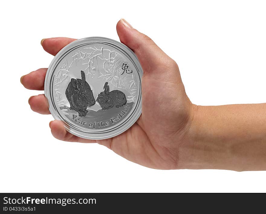 Woman having in the palm hand Year of the Rabbit silver coin.