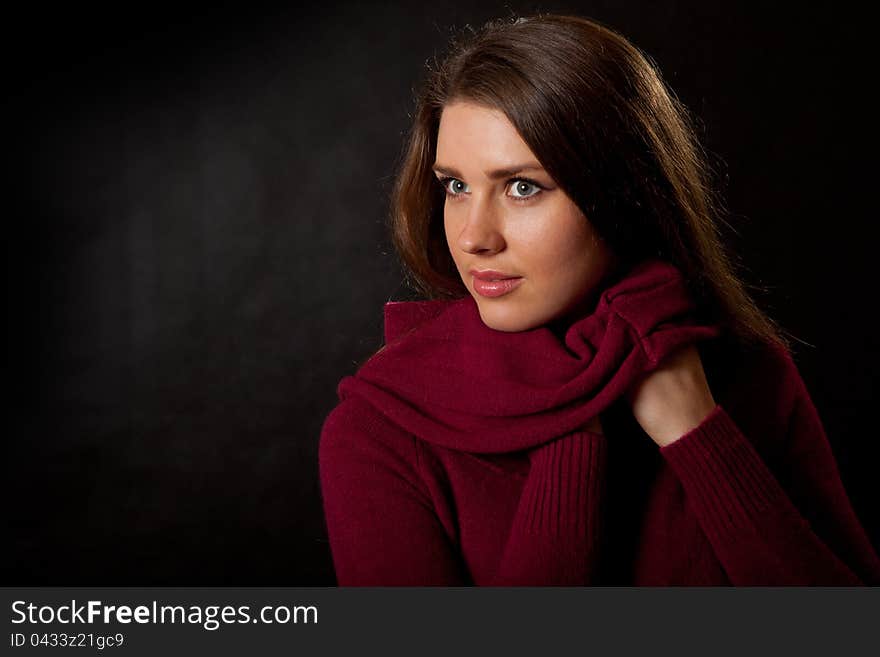 Portrait of the young girl on a black background