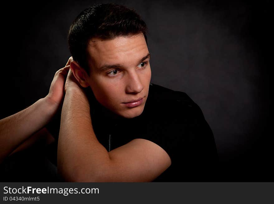 Studio portrait of the guy on a black background. Studio portrait of the guy on a black background