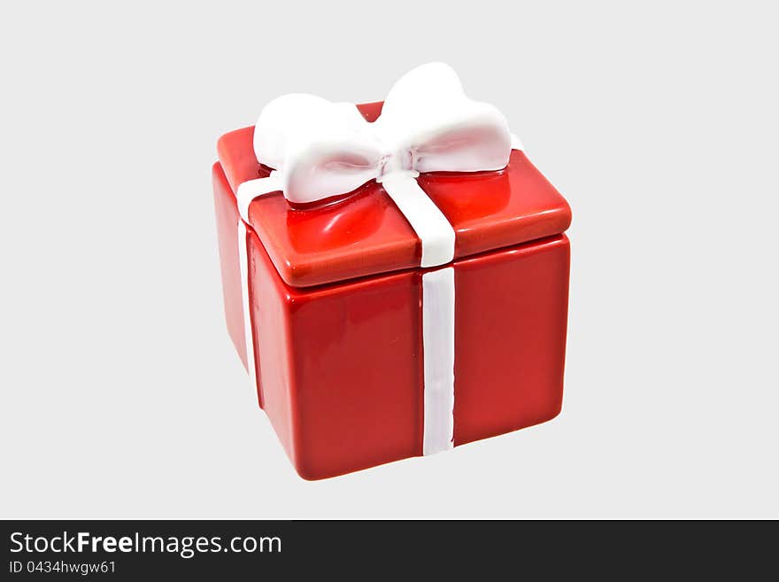 Gift box with white ribbon on gray background