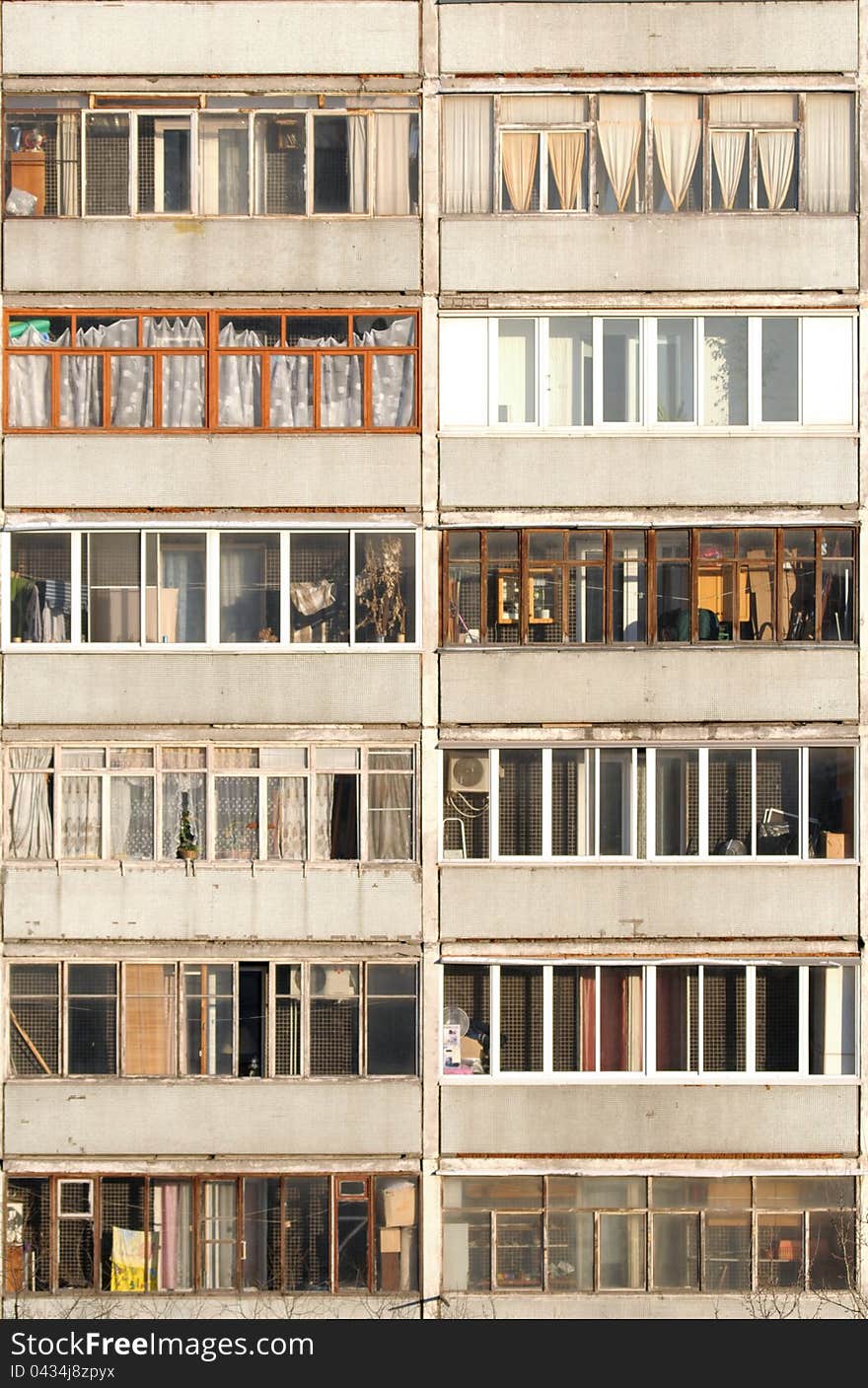 Block of apartments with balconies. Vertical shot.