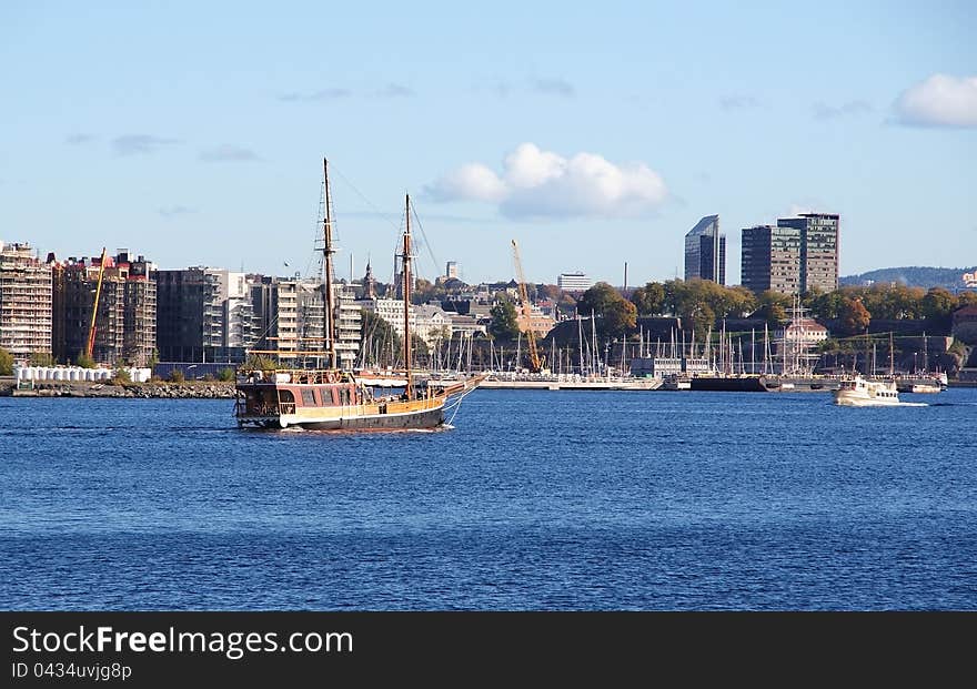 Cityscape With Boats In Bay.