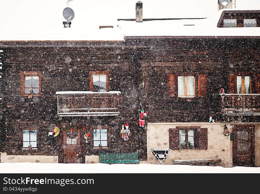 Snowing In Front Of Traditional House