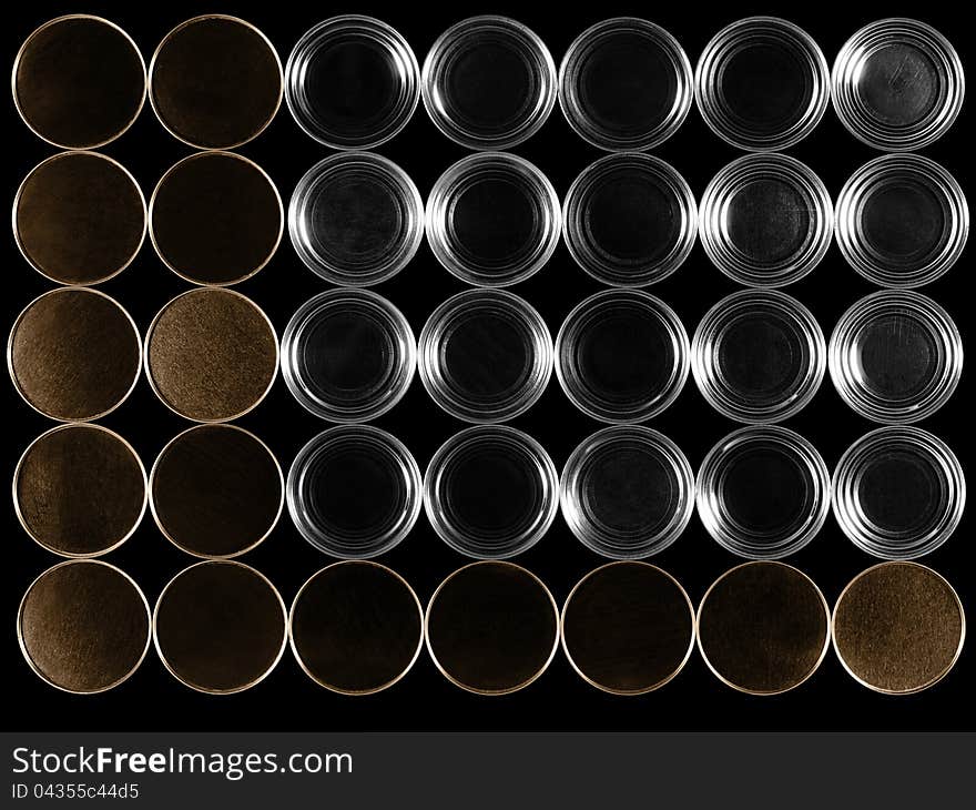 Bottoms of cans on a black background.