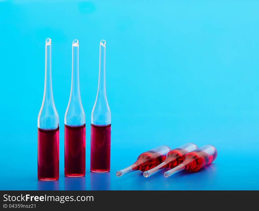 Medical ampoules on a blue background are closed