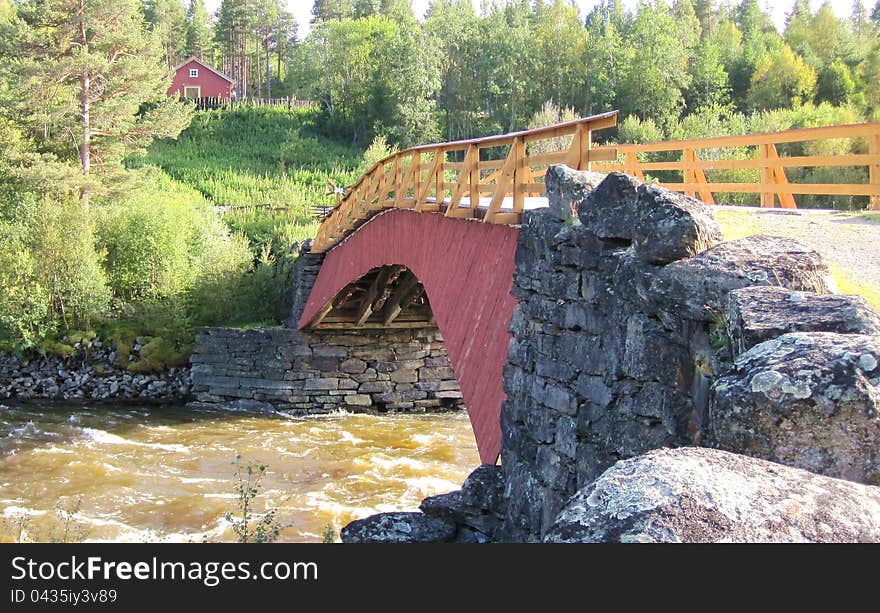 Old wooden bridge over a river in Norway. Old wooden bridge over a river in Norway