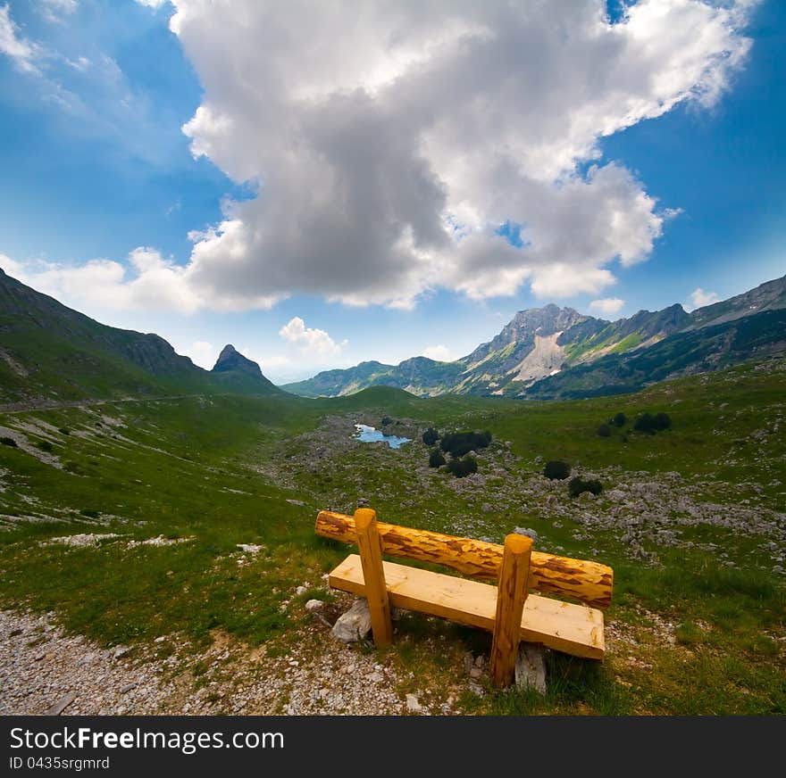 Solitary bench  on Alps valley