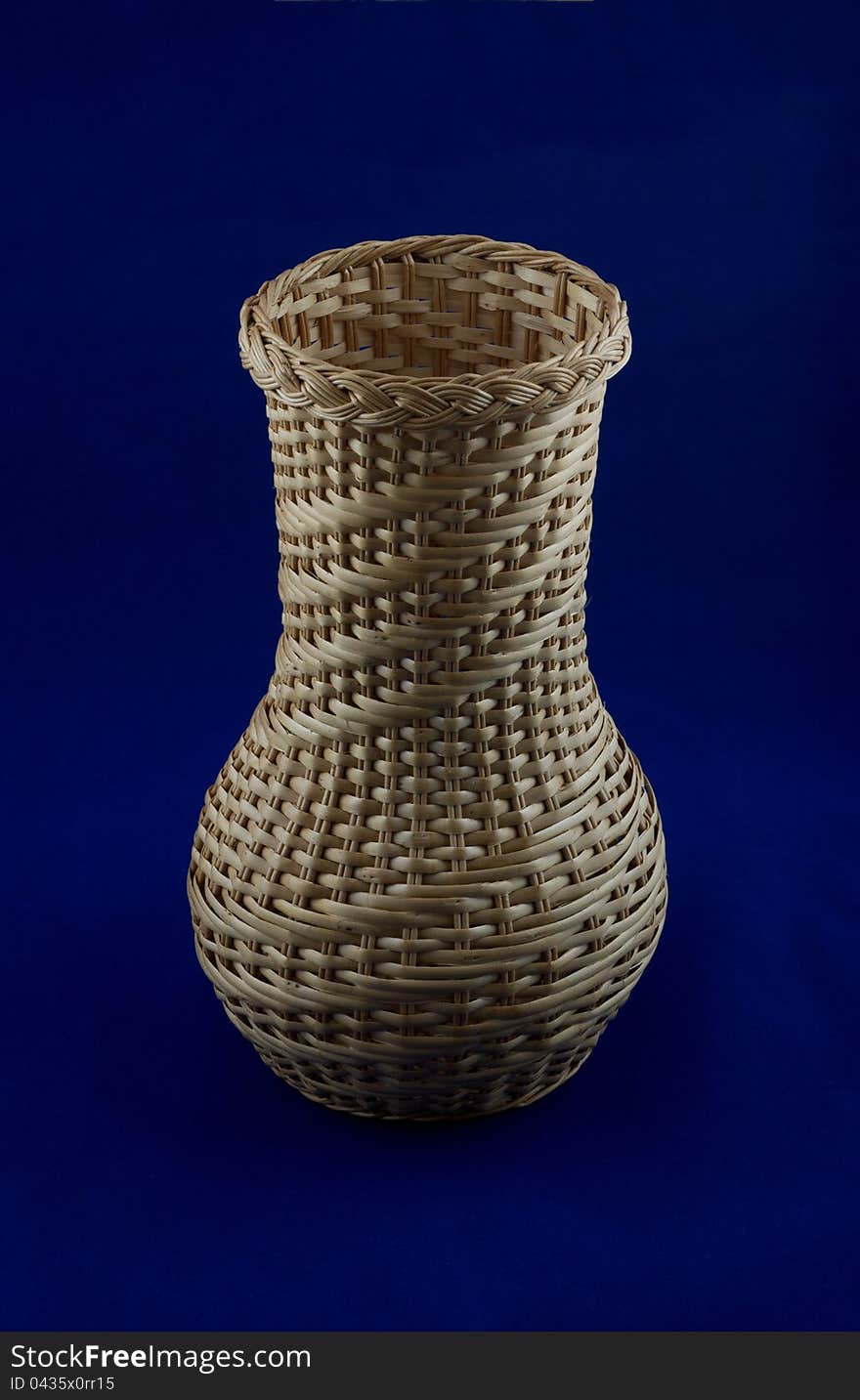 Wicker vase isolated on a blue background