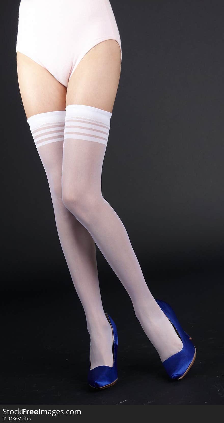 Legs In White Stockings And Blue Heels