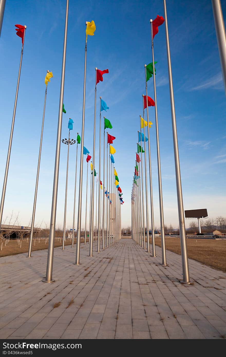 Colorful flying flag under blue sky