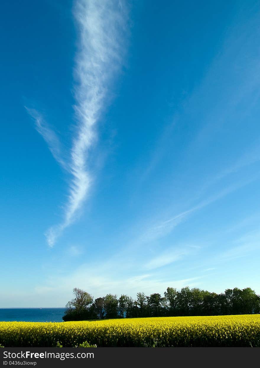 Beautiful cloudscape clouds formation over fields and seascape