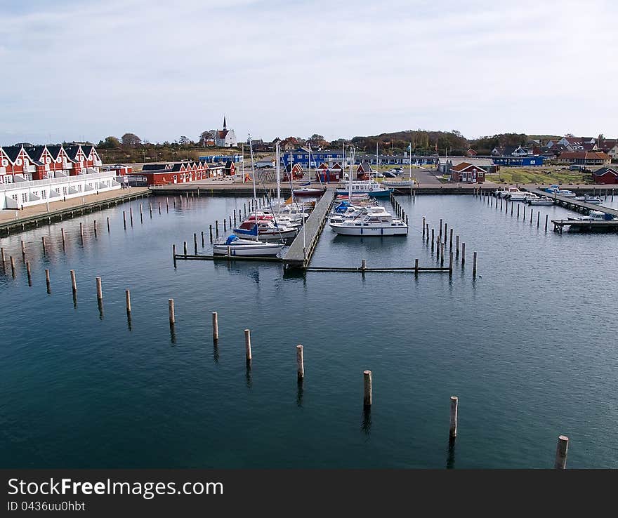 Modern neo classical design wooden beach summer houses in a small marina Langeland Denmark. Modern neo classical design wooden beach summer houses in a small marina Langeland Denmark