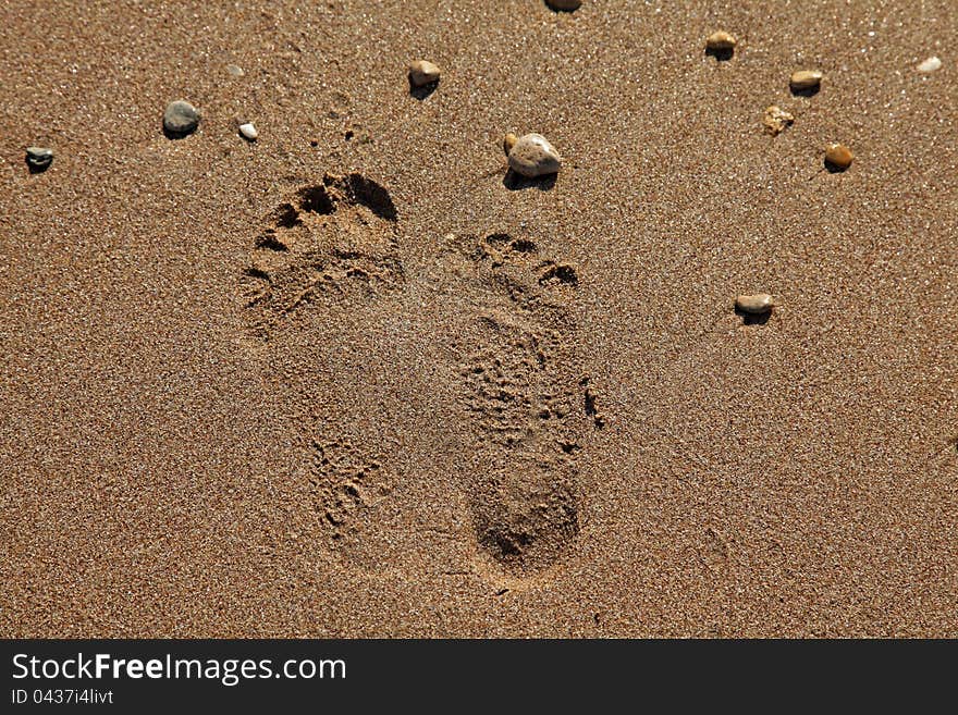 Two different footprints on sand