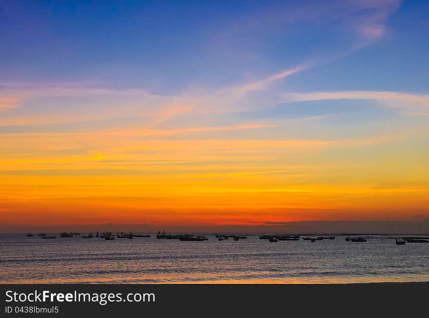 Ocean coast sunset and fishing boats