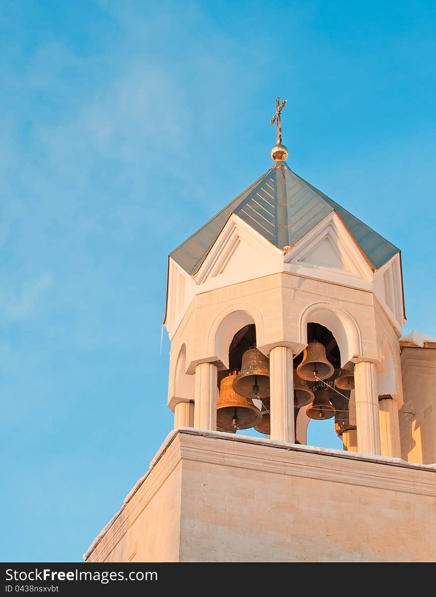 Beautiful bell tower of the temple against the blue sky