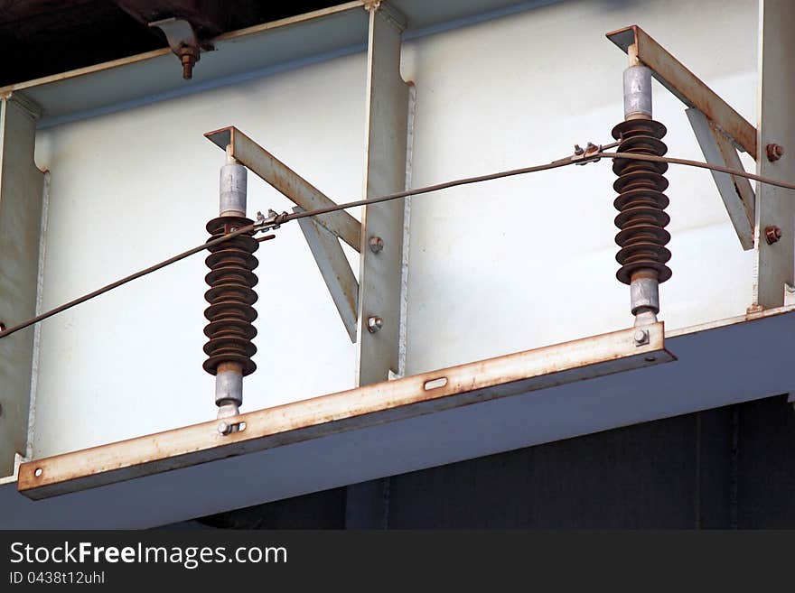 Two electrical insulators on iron construction