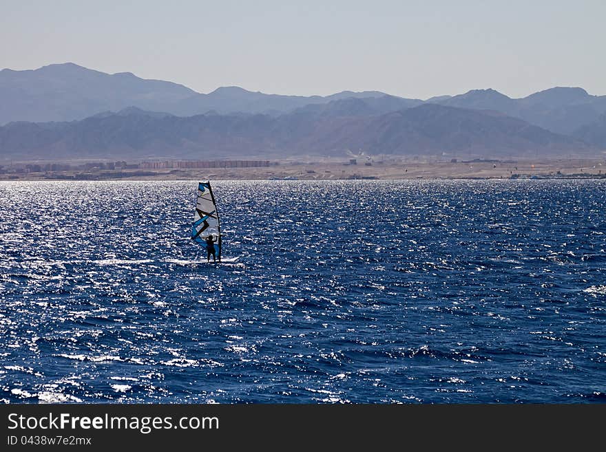 Unidentified man windsurfing in Red Sea waters in Egypt, Safaga, on October 2011. Unidentified man windsurfing in Red Sea waters in Egypt, Safaga, on October 2011