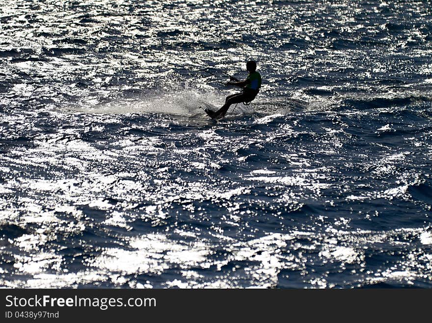 Silhouette Of Kitesurfer In Back Lighting