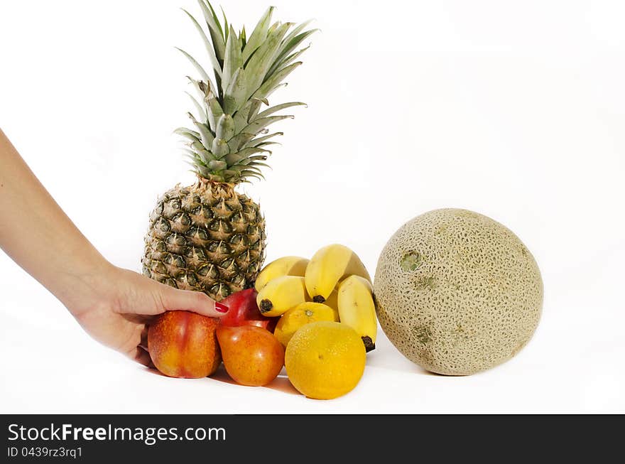 Woman hand picking tropical fruits at supermarket or some other place.