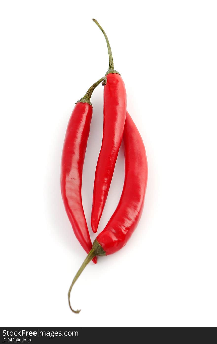 Three hot red chili peppers isolated on a white background