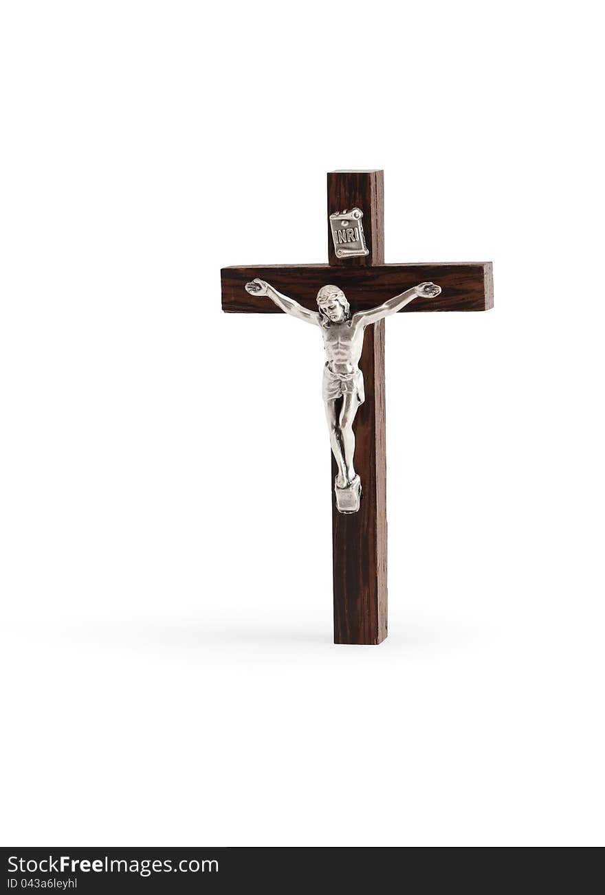 Small wooden crucifix standing on white background. Isolated with clipping path. Small wooden crucifix standing on white background. Isolated with clipping path