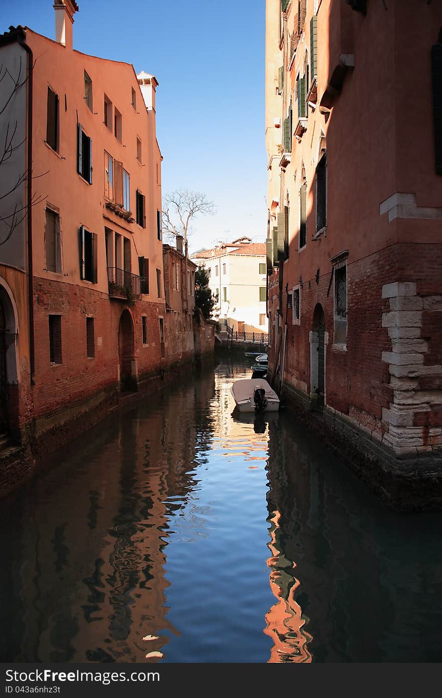 Few boats on a narrow canal between old buildings. Venice, Italy. Few boats on a narrow canal between old buildings. Venice, Italy