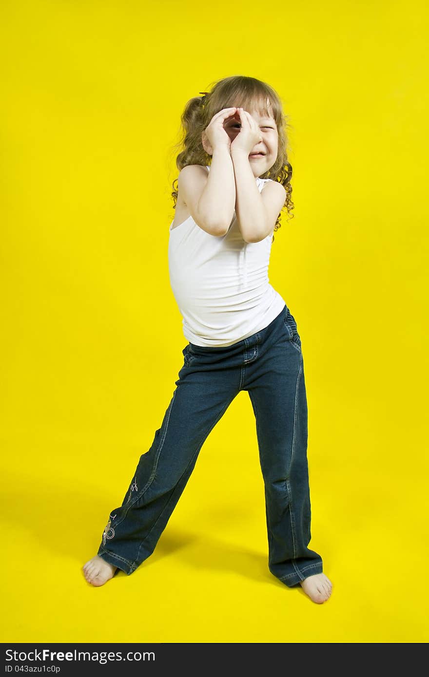 Cheerful girl on a yellow background