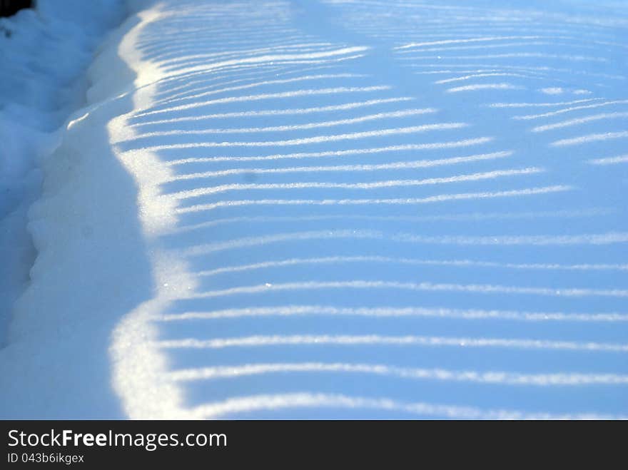 Light and snow creating a beautiful texture. Light and snow creating a beautiful texture