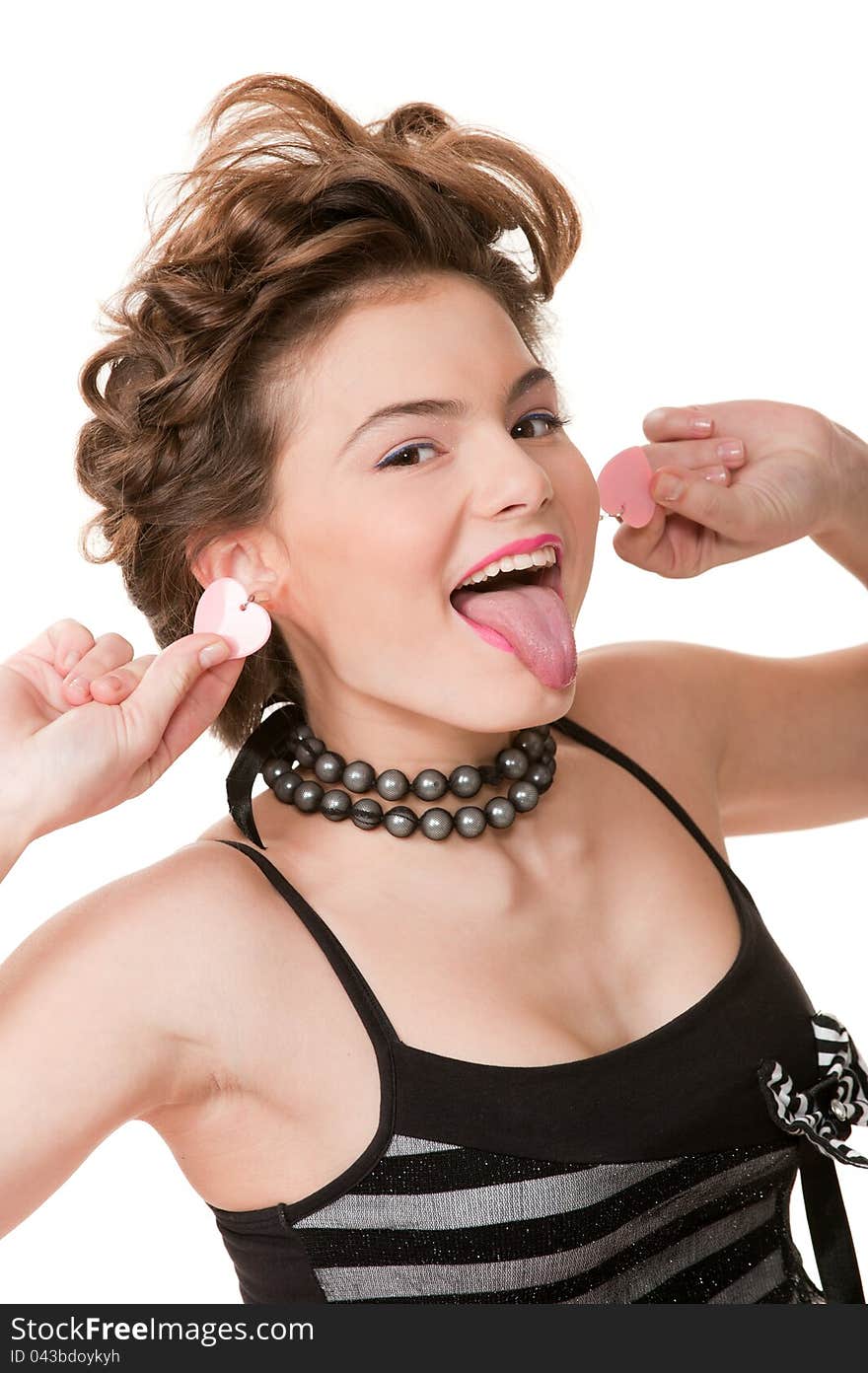 Portrait of cute playful girl posing in the studio showing his tongue at the camera. Portrait of cute playful girl posing in the studio showing his tongue at the camera