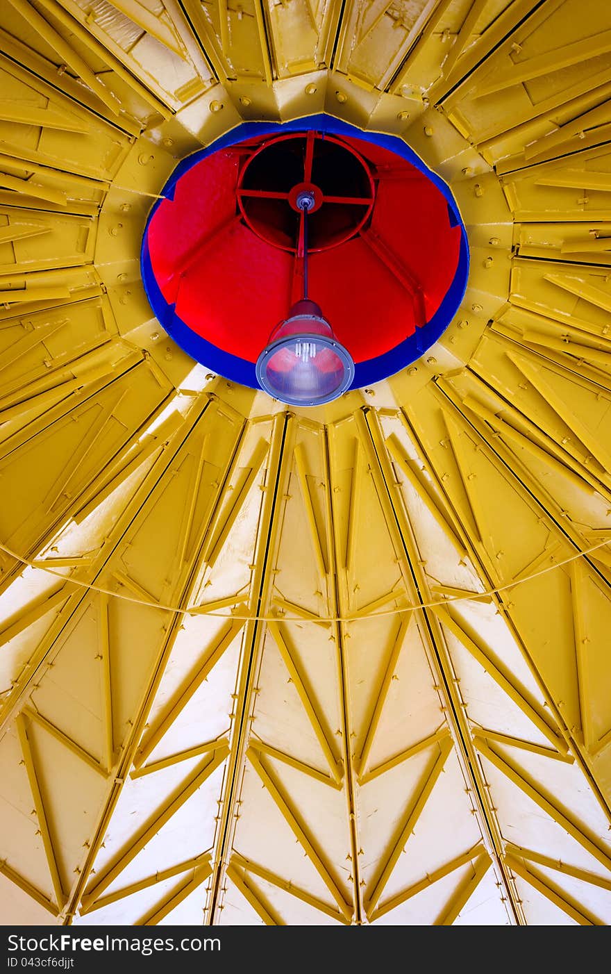 Bright colored red, blue and yellow metal work with center lamp architectural background. Bright colored red, blue and yellow metal work with center lamp architectural background.