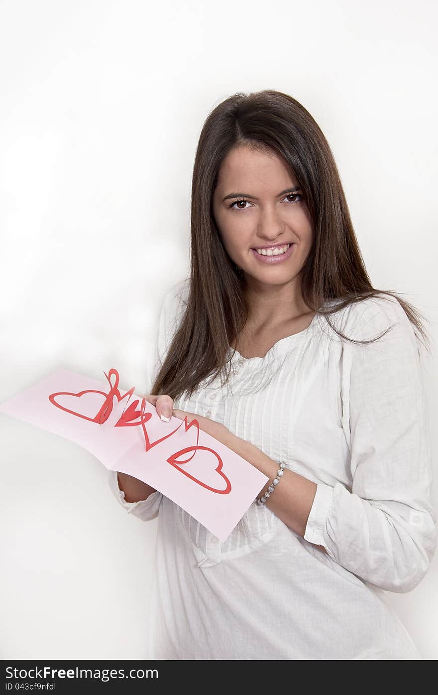 Young girl with card with pop up hearts