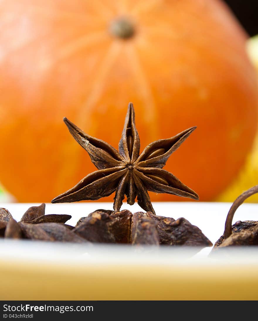 Anise seeds on orange background. Anise seeds on orange background.