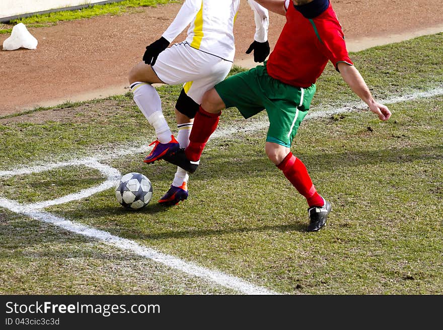 Two players are challenging to get the ball. Two players are challenging to get the ball